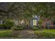 Charming home with a welcoming front porch, a well-manicured lawn, and mature trees at 209 Barberry St, Summerville, SC 29483