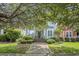 Charming home with a welcoming front porch, a well-manicured lawn, and mature trees at 209 Barberry St, Summerville, SC 29483