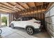 Spacious garage interior featuring a white car parked inside on a concrete floor at 209 Barberry St, Summerville, SC 29483
