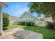 Exterior view of a detached garage with light green siding and a white picket fence surrounding manicured lawn at 209 Barberry St, Summerville, SC 29483