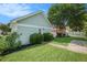 Exterior view of detached garage with light green siding, lush landscaping, and a charming white picket fence at 209 Barberry St, Summerville, SC 29483