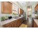 Well-lit kitchen with wood cabinets, stainless steel appliances, and a window offering natural light and a view of the exterior at 209 Barberry St, Summerville, SC 29483