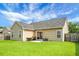 Spacious backyard with a well-maintained lawn, patio, and privacy fence, ideal for outdoor gatherings at 213 Avonshire Dr, Summerville, SC 29483