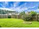 Green backyard with a wood fence line, plants, and a grass lawn at 213 Avonshire Dr, Summerville, SC 29483