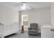 Cozy Bedroom with a white crib, comfortable chair, and soft gray carpet, perfect for a young Gathering at 213 Avonshire Dr, Summerville, SC 29483