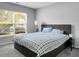 Comfortable bedroom with a large window providing natural light, and a bed with a blue plaid comforter at 213 Avonshire Dr, Summerville, SC 29483