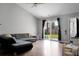 Bright living room with vaulted ceilings, wood floors, sliding glass doors, and a comfortable gray sofa at 213 Avonshire Dr, Summerville, SC 29483