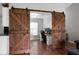 Home office featuring sliding barn doors and wood laminate floors at 213 Avonshire Dr, Summerville, SC 29483