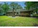 Brick home with patio and table in grassy backyard at 215 Bramblewood Dr, Summerville, SC 29485