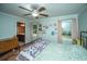 Cozy bedroom with light green walls, hardwood floors, natural light, and ceiling fan at 215 Bramblewood Dr, Summerville, SC 29485