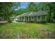 Charming brick home featuring well-maintained lawn, front porch, and colorful shutters at 215 Bramblewood Dr, Summerville, SC 29485