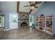 Living room displaying a brick fireplace, white trim, hardwood floors, and large windows at 215 Bramblewood Dr, Summerville, SC 29485