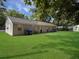 Expansive backyard featuring healthy green grass and trash receptacles at 2174 Eleanor Dr, North Charleston, SC 29406