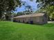 Spacious backyard with healthy green grass and convenient trash receptacles at 2174 Eleanor Dr, North Charleston, SC 29406