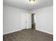 Inviting bedroom with grey wood-look floors, white walls, and a bi-fold closet door at 2174 Eleanor Dr, North Charleston, SC 29406