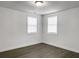Bedroom with hardwood floors and natural light from two windows at 2174 Eleanor Dr, North Charleston, SC 29406