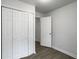 Clean bedroom featuring folding closet doors, grey hardwood-look floors, and white walls at 2174 Eleanor Dr, North Charleston, SC 29406