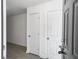 Entryway with a dark front door, two white interior doors, and wood floors at 2174 Eleanor Dr, North Charleston, SC 29406