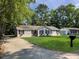 Charming single-story home with well-maintained lawn, mailbox and blooming window boxes at 2174 Eleanor Dr, North Charleston, SC 29406