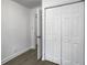 Hallway with wood floors, closet with folding doors, and several doorways leading to other rooms at 2174 Eleanor Dr, North Charleston, SC 29406