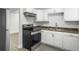 Modern kitchen featuring an electric range oven, stainless steel sink, and ample white cabinets at 2174 Eleanor Dr, North Charleston, SC 29406