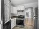View of the kitchen with stainless steel appliances and new flooring throughout the home at 2174 Eleanor Dr, North Charleston, SC 29406