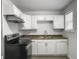 Bright kitchen with stainless steel appliances, white cabinets and laminate countertops at 2174 Eleanor Dr, North Charleston, SC 29406