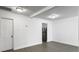 Bright living room featuring gray flooring, access to kitchen with stainless steel fridge, and white interior at 2174 Eleanor Dr, North Charleston, SC 29406