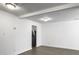 Open living space with white walls, gray floors, and access to a kitchen area with stainless steel refrigerator at 2174 Eleanor Dr, North Charleston, SC 29406