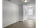 Living room area with gray floors and white walls; multiple entry and exit doors at 2174 Eleanor Dr, North Charleston, SC 29406