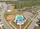 Aerial shot showcasing a community pool and playground near a pond and wooded area at 224 Wappoo Trace Ln, Summerville, SC 29486