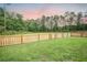 Spacious backyard with lush green grass and a wooden fence for privacy at 224 Wappoo Trace Ln, Summerville, SC 29486
