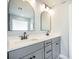 Bathroom featuring a dual sink vanity with mirrors, neutral walls, and patterned tile flooring at 224 Wappoo Trace Ln, Summerville, SC 29486