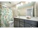 Bathroom with a large mirror, a single sink, and a patterned shower curtain at 224 Wappoo Trace Ln, Summerville, SC 29486