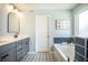 Stylish bathroom featuring dual vanity, standalone tub, and patterned tile flooring at 224 Wappoo Trace Ln, Summerville, SC 29486
