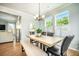 Dining room features a live edge wood table, designer lighting, and natural light at 224 Wappoo Trace Ln, Summerville, SC 29486