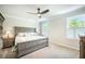 Serene main bedroom featuring a spacious bed, carpet, modern ceiling fan, and natural light from shuttered windows at 224 Wappoo Trace Ln, Summerville, SC 29486