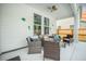 Covered patio with seating area, fan, and decorative wall art creates a relaxing outdoor space at 224 Wappoo Trace Ln, Summerville, SC 29486
