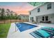 Stunning pool in a backyard with covered patio, fenced perimeter, and lush greenery at 224 Wappoo Trace Ln, Summerville, SC 29486
