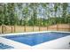 In-ground pool surrounded by lush trees and greenery with fountain features at 224 Wappoo Trace Ln, Summerville, SC 29486