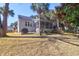 Expansive backyard with a deck, lush grass, and mature trees offering shade and privacy to the home at 2257 Magnolia Meadows Dr, Mount Pleasant, SC 29464