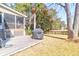 Well-maintained backyard featuring a wooden deck, grill, and lush lawn with mature trees for shade at 2257 Magnolia Meadows Dr, Mount Pleasant, SC 29464