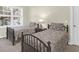 Bright bedroom featuring two twin beds, bedside table with lamp, and natural light from a window at 2257 Magnolia Meadows Dr, Mount Pleasant, SC 29464