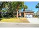 Charming brick home with a well-manicured lawn, palm trees, and a two-car garage at 2257 Magnolia Meadows Dr, Mount Pleasant, SC 29464