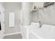 Well-lit laundry room featuring a washer and dryer, storage cabinet, and shelving unit for supplies at 2257 Magnolia Meadows Dr, Mount Pleasant, SC 29464