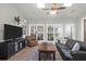 Inviting living room with tile floors, large windows, and a comfortable sofa at 2257 Magnolia Meadows Dr, Mount Pleasant, SC 29464