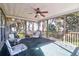 Inviting screened porch featuring comfortable seating arrangements, a ceiling fan, and scenic backyard views at 2257 Magnolia Meadows Dr, Mount Pleasant, SC 29464