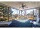 Relaxing screened porch with a ceiling fan, comfortable seating, and views of the surrounding landscape at 2257 Magnolia Meadows Dr, Mount Pleasant, SC 29464