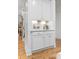 Modern bar area with white cabinetry, a gold faucet, and stylish decor accents at 2293 Beckenham Dr, Mount Pleasant, SC 29466