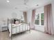 The light-filled bedroom features a metal bed frame, and decorative, pink curtains at 2293 Beckenham Dr, Mount Pleasant, SC 29466